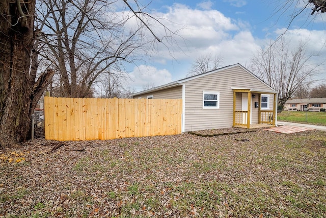 view of outbuilding featuring fence