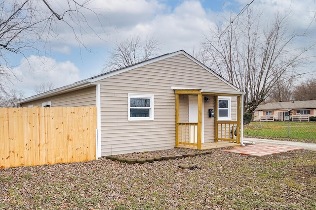 view of outbuilding featuring fence