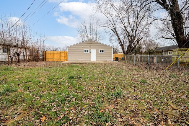 view of yard featuring an outdoor structure and a fenced backyard