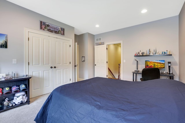 carpeted bedroom with a closet, visible vents, and recessed lighting