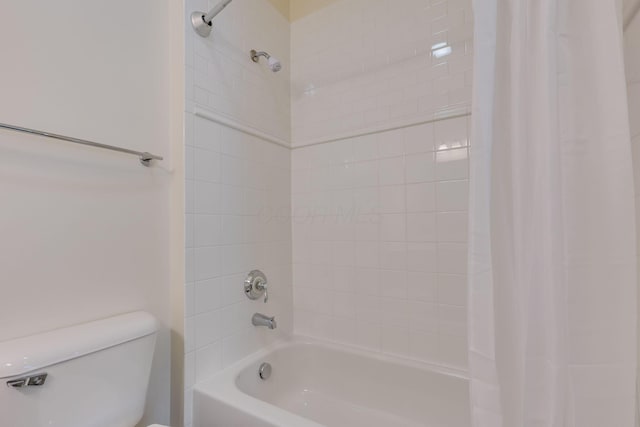 bathroom featuring toilet and shower / bath combo with shower curtain