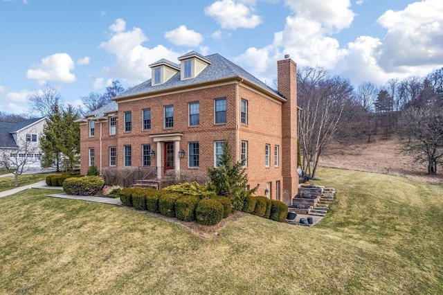 view of front of property with a front yard and brick siding