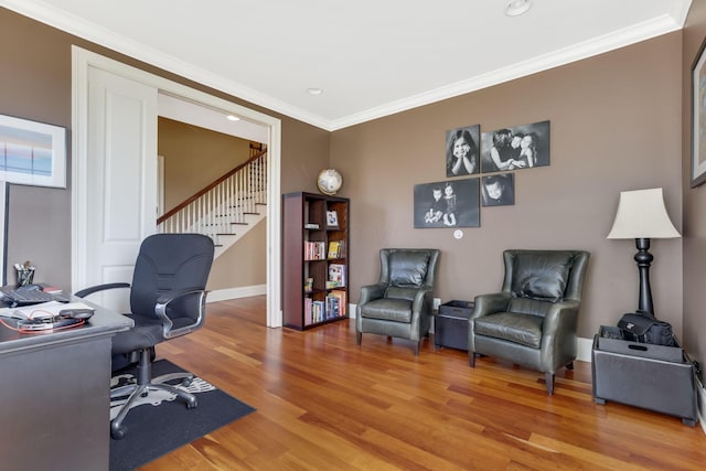 office space with light wood-style floors, baseboards, ornamental molding, and recessed lighting