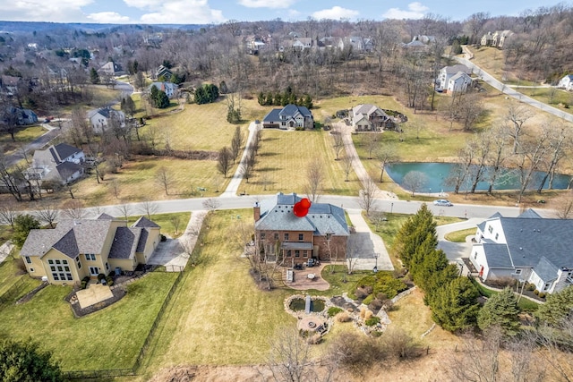 drone / aerial view with a residential view and a water view