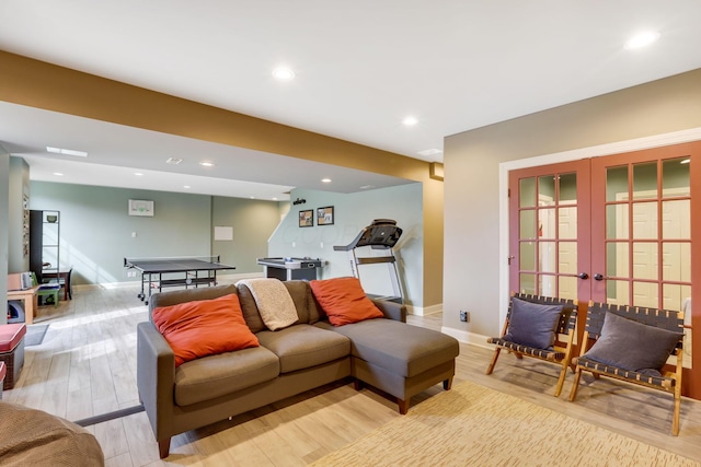 living area with light wood-type flooring, recessed lighting, baseboards, and french doors