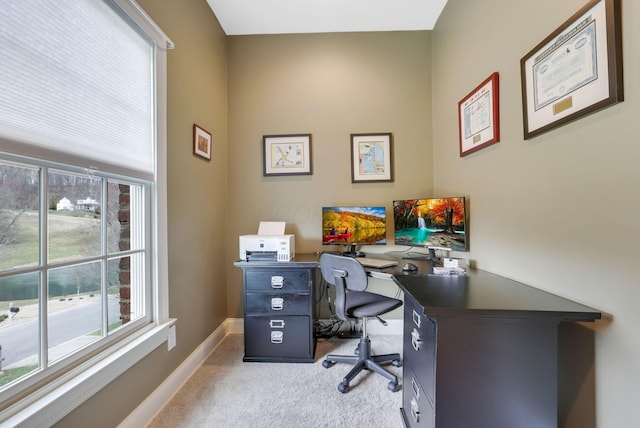 carpeted office space featuring baseboards