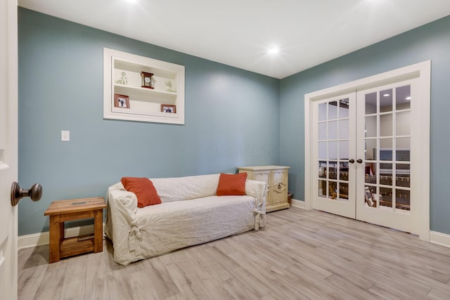 living area with recessed lighting, baseboards, wood finished floors, and french doors