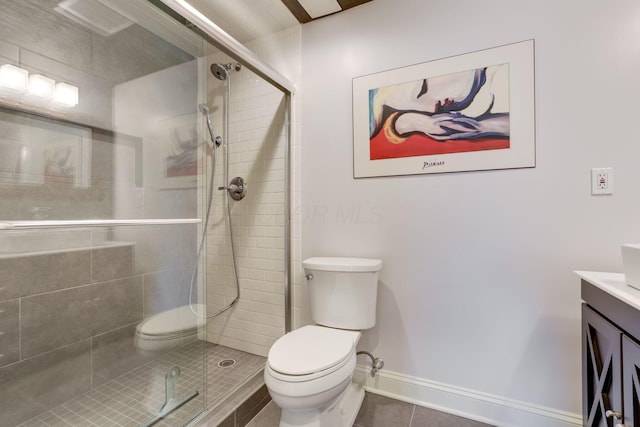 full bathroom featuring a stall shower, vanity, toilet, and tile patterned floors