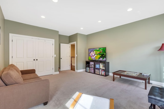 living room featuring recessed lighting, light carpet, and baseboards