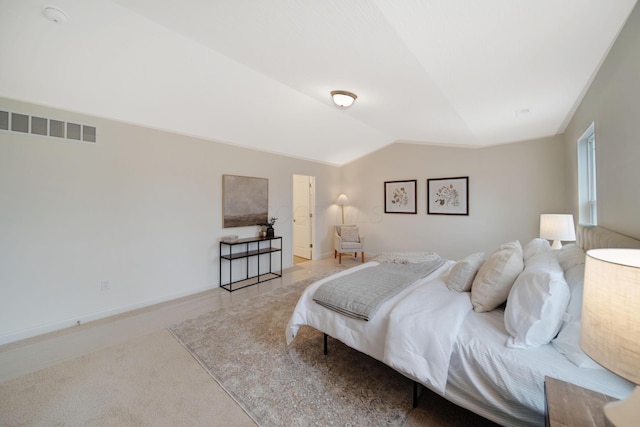 bedroom featuring visible vents, lofted ceiling, baseboards, and carpet flooring