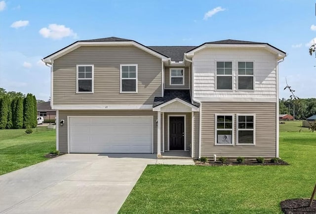 view of front of property featuring driveway, an attached garage, and a front yard