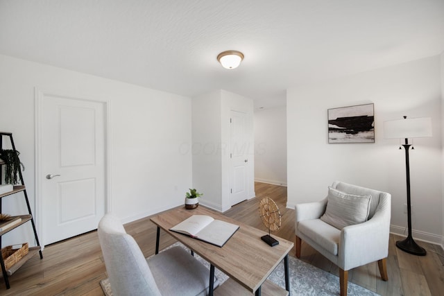 office area with baseboards and light wood-style floors