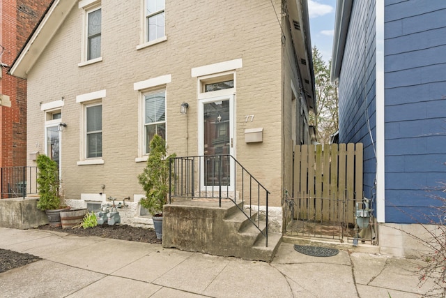 entrance to property featuring brick siding