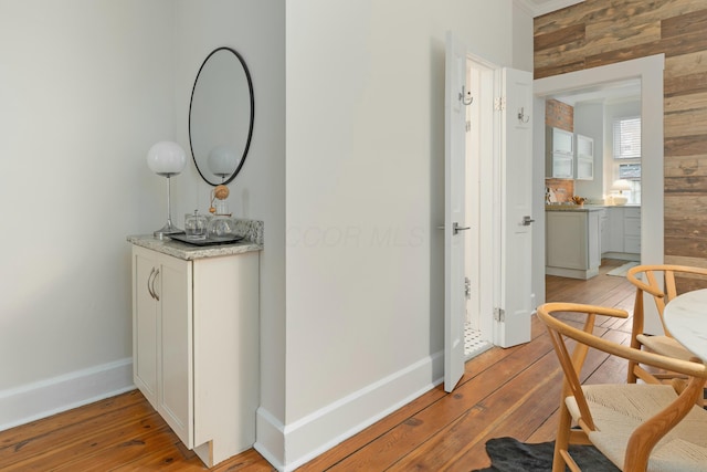 hallway featuring light wood-style floors and baseboards