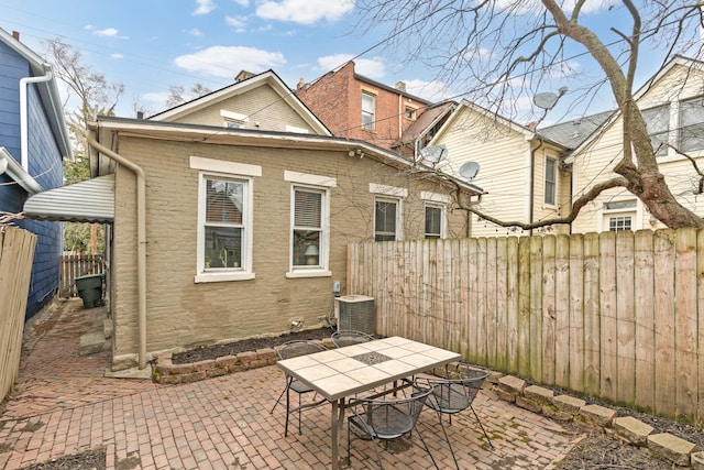 view of patio / terrace with a fenced backyard, central AC, and outdoor dining space