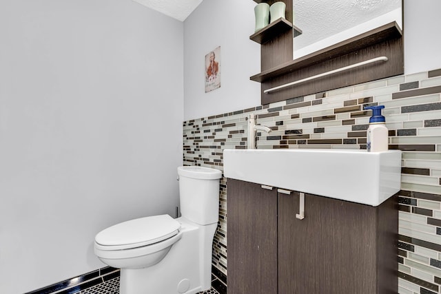 half bathroom with vanity, toilet, and tile walls