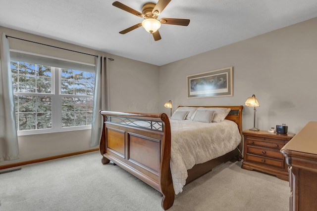 bedroom featuring a ceiling fan, light carpet, visible vents, and baseboards