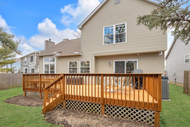 back of property featuring a chimney, central air condition unit, a lawn, fence, and a deck