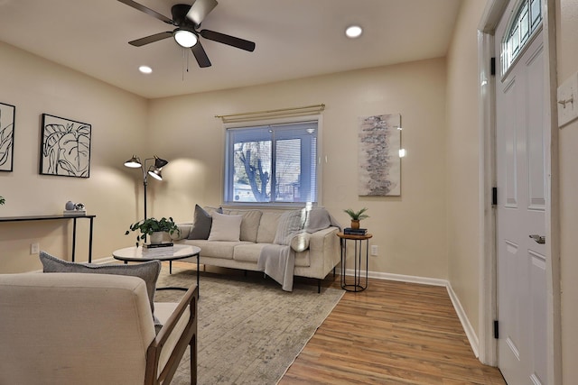 living area with ceiling fan, recessed lighting, wood finished floors, and baseboards