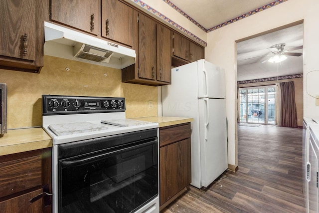 kitchen with freestanding refrigerator, light countertops, range with electric stovetop, and under cabinet range hood