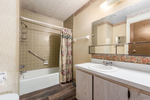 bathroom featuring shower / bath combo, wood finished floors, vanity, and wallpapered walls