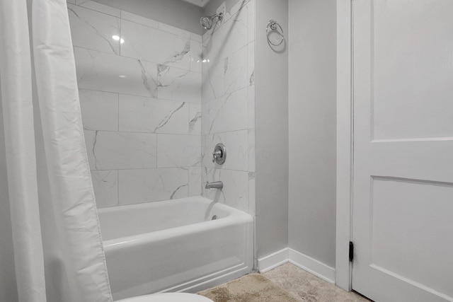 full bathroom featuring baseboards and shower / bath combination with curtain