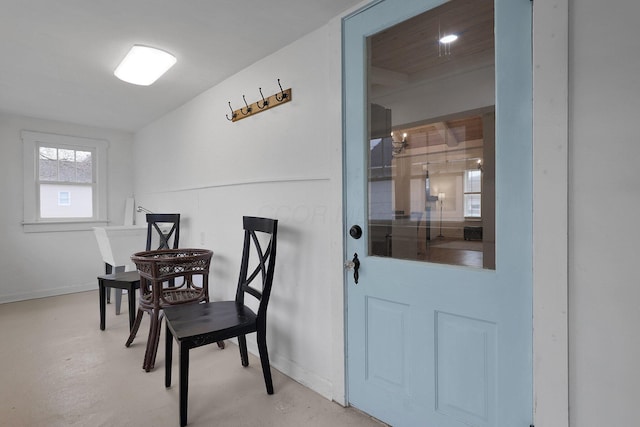 dining space featuring concrete floors and baseboards