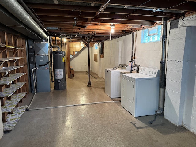 below grade area with heating unit, gas water heater, light floors, and separate washer and dryer