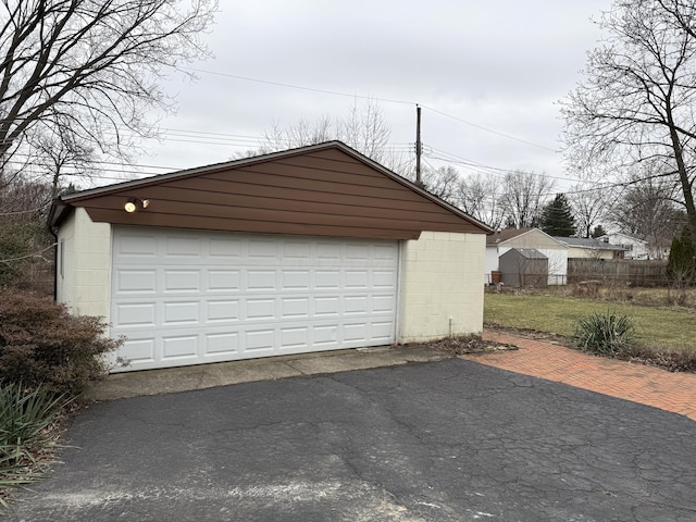 detached garage featuring fence