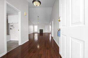 hall with baseboards and wood finished floors