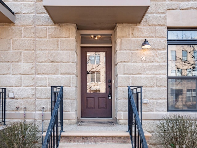 doorway to property featuring stone siding