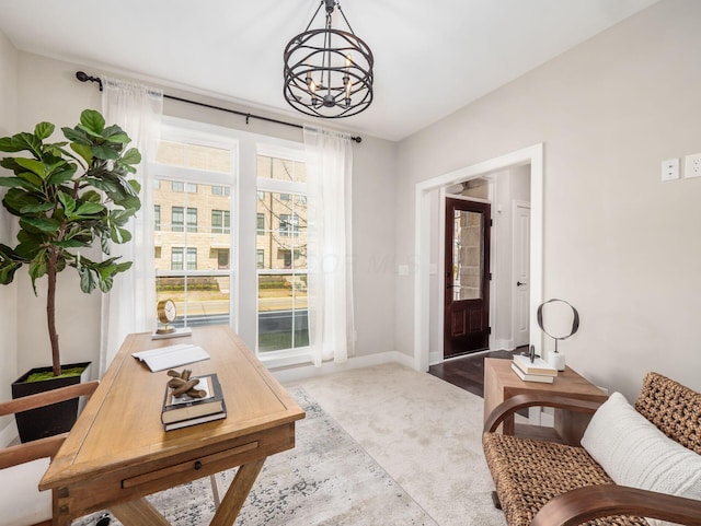 office space with baseboards and an inviting chandelier