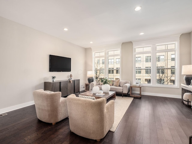 living area with recessed lighting, dark wood-style floors, and baseboards