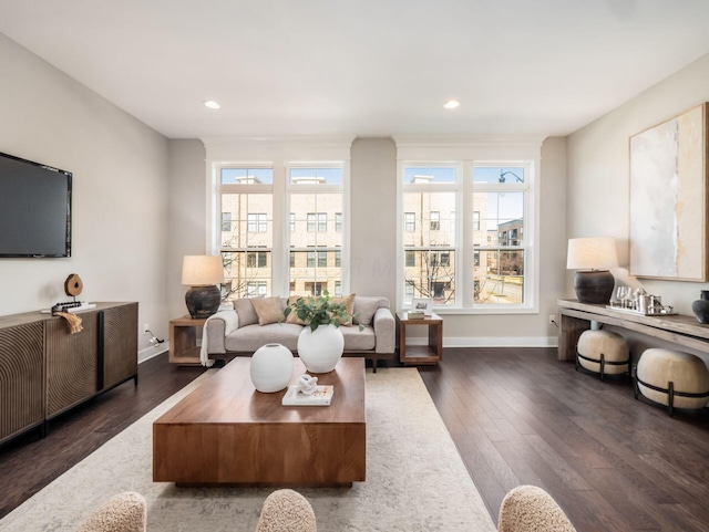 living room with recessed lighting, baseboards, and dark wood-style flooring