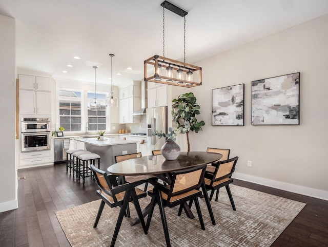 dining room with dark wood-style floors, recessed lighting, and baseboards