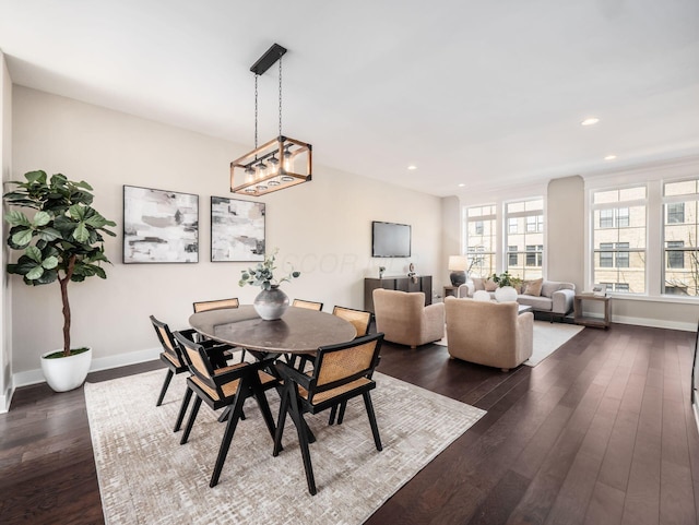 dining area with dark wood-type flooring, recessed lighting, and baseboards