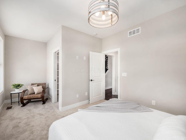 bedroom with an inviting chandelier, carpet, visible vents, and baseboards