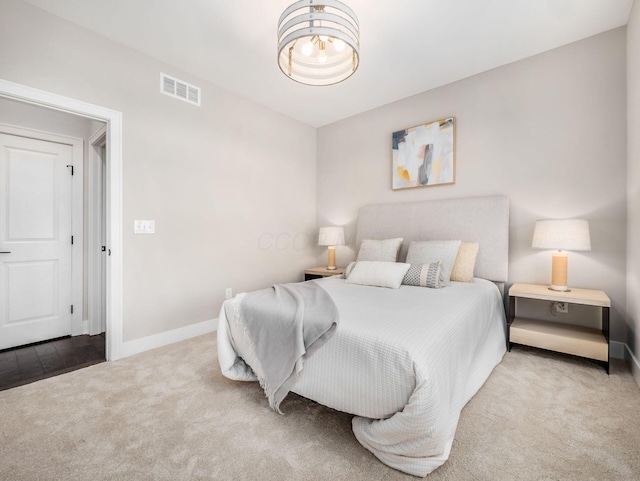 bedroom featuring visible vents, carpet floors, and baseboards