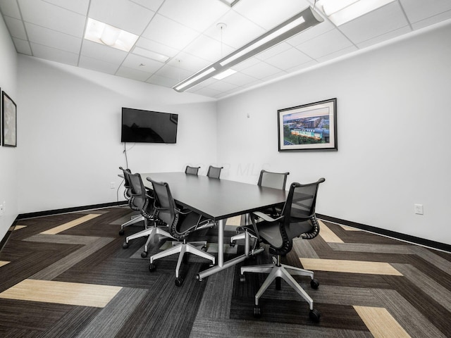 office area featuring a drop ceiling, baseboards, and carpet floors