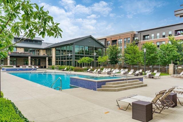 community pool with a patio and fence