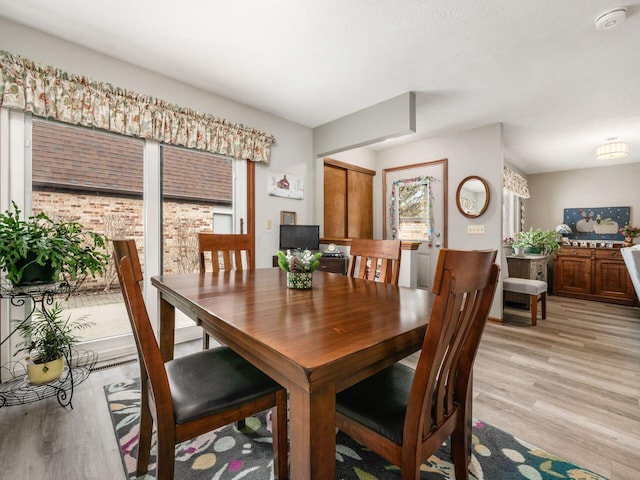 dining room with light wood-style flooring