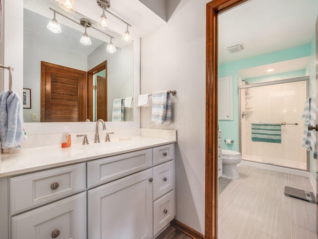 full bathroom featuring toilet, a stall shower, vanity, and visible vents