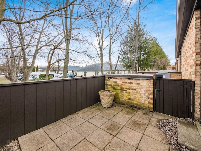 view of patio featuring a gate and fence