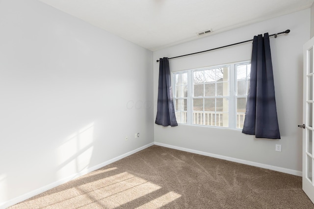 unfurnished room with visible vents, french doors, carpet, and baseboards