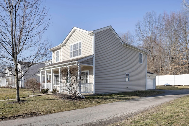 view of home's exterior featuring a porch, a garage, and fence