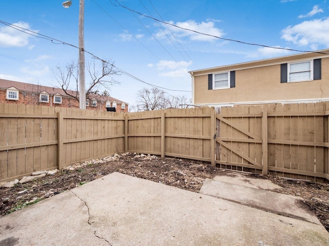 view of patio featuring a fenced backyard and a gate