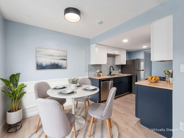 dining room featuring light wood-type flooring and recessed lighting