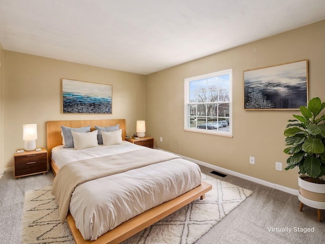 bedroom with light colored carpet, visible vents, and baseboards