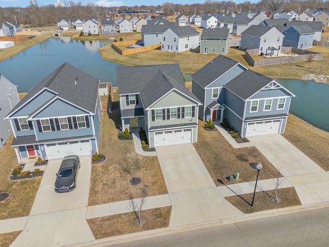 drone / aerial view with a residential view and a water view