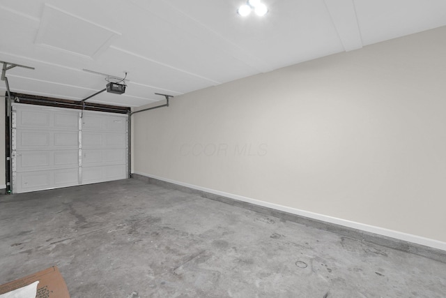 garage with baseboards and a garage door opener